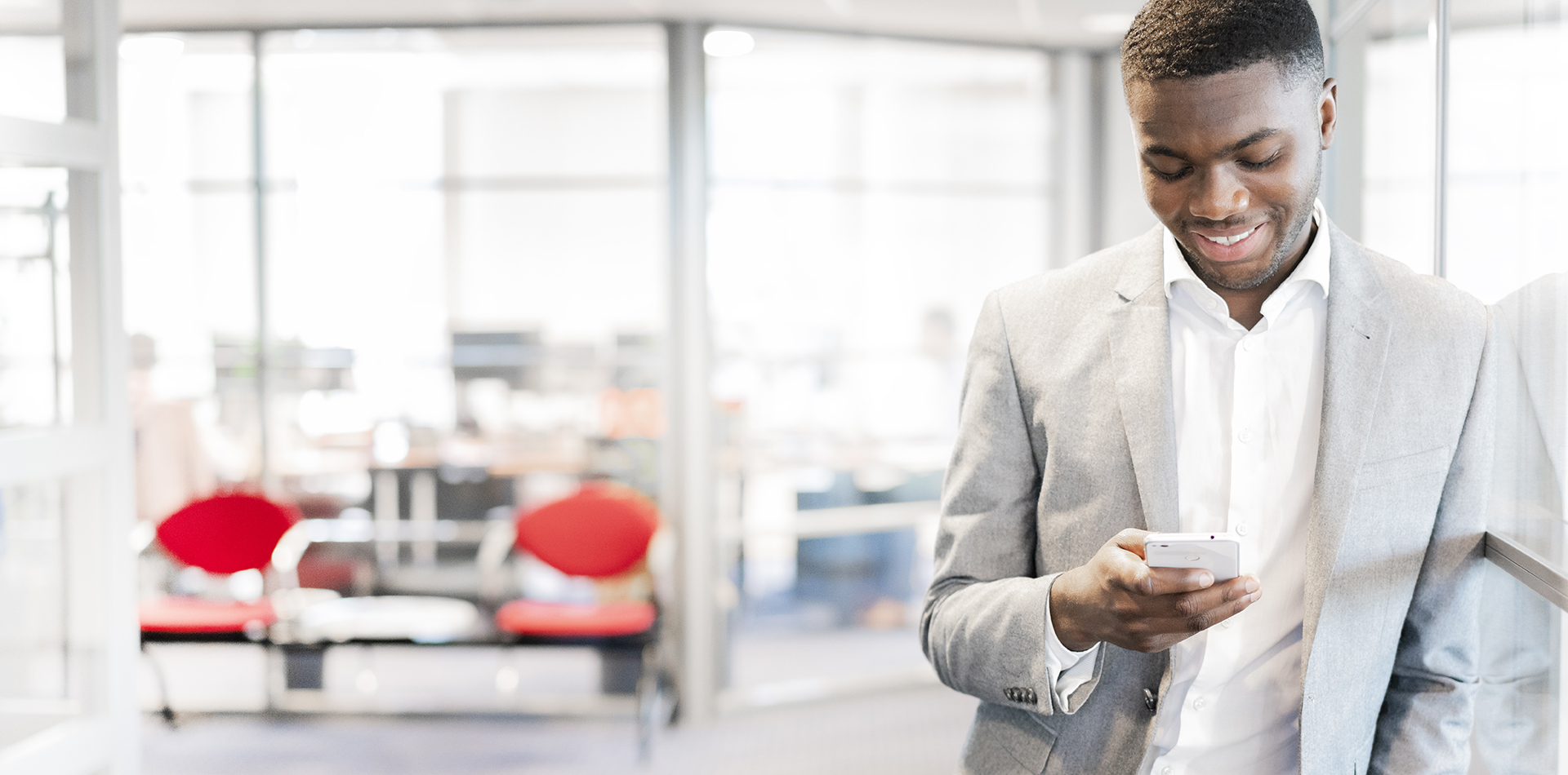 Man managing tank container services online on his mobile phone 