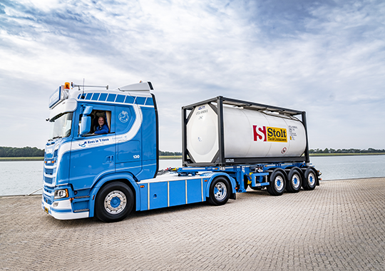 Truck with Stolt Tank Container next to waterline Truck with Tank Container