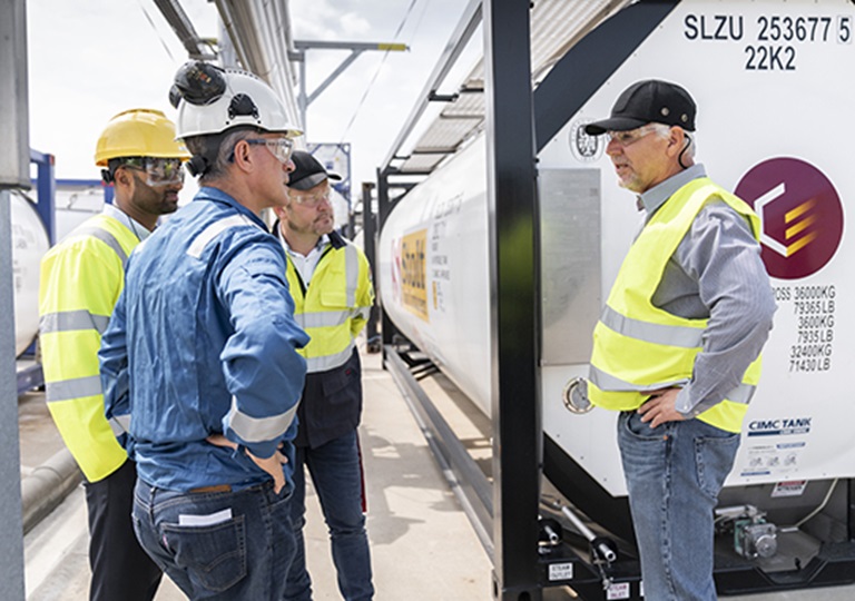 Four men discussing tank container solution