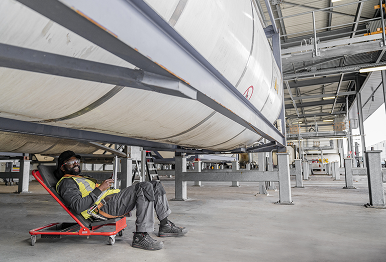 Stolt Tank Containers professional inspecting docked tank container