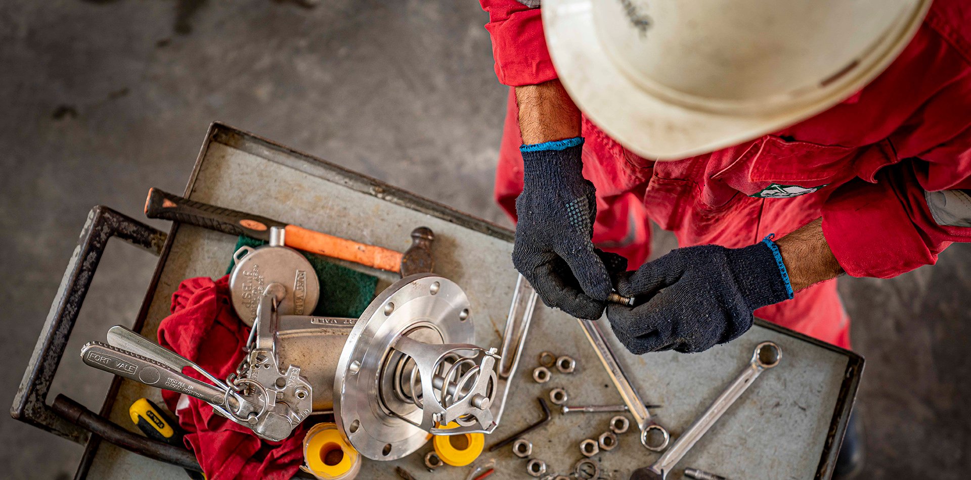 Depot worker doing maintenance of tank container element